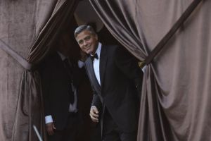 U.S. actor Clooney smiles as he arrives by taxi boat to the venue of a gala dinner ahead of his official wedding ceremony in Venice